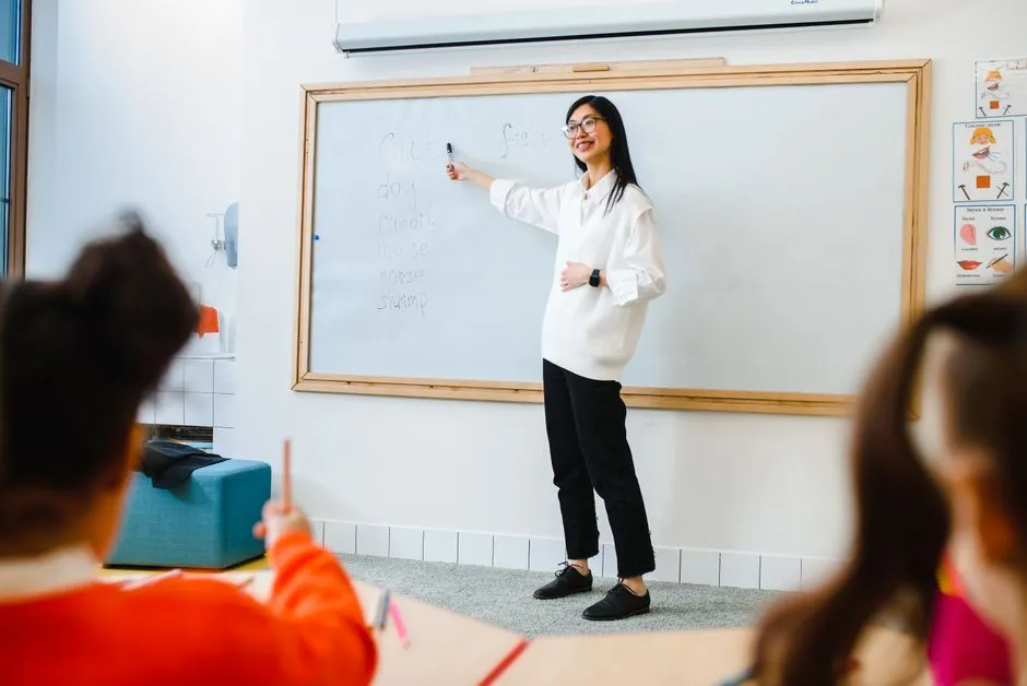 Primary school class code written in chalk on a classroom whiteboard beside a maths heading